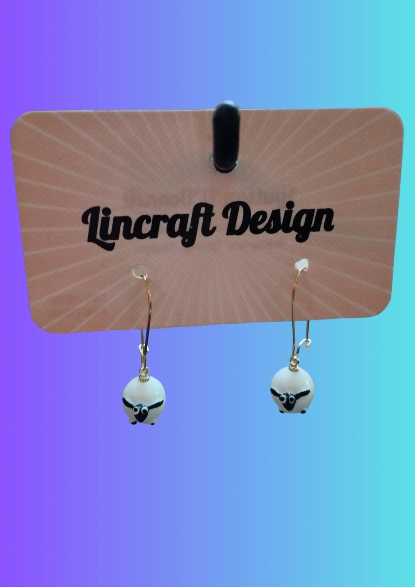 "Fluffy Sheep Resin Earrings - Handmade Irish Jewelry by Lindsay O'Donnell. On display card